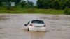 Couple Swept Away: Tragic... Former Sarpanch's car washed away in a swollen stream! Couple missing; driver saved himself by jumping out... Search for the couple underway.